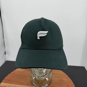 Fabletics the city trucker hat in everpine dark green with a white logo by khloe